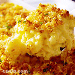 A Close Up Of A Casserole Dish With Macaroni And Cheese On A Spoon GIF
