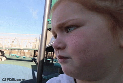 A Close Up Of A Child 'S Face In A Park GIF