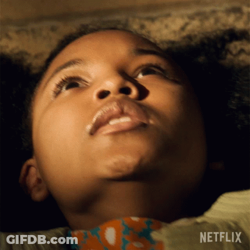 A Close Up Of A Child 'S Face With A Netflix Logo Behind Her GIF
