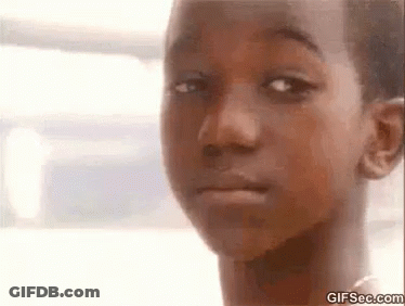 A Close Up Of A Child 'S Face With A Serious Look On His Face . GIF