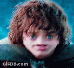 A Close Up Of A Child 'S Face With Blue Eyes GIF