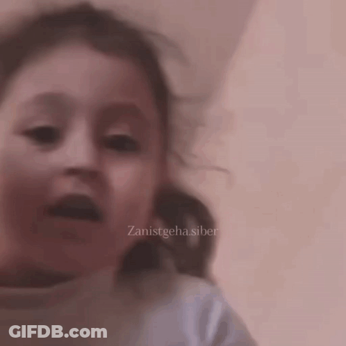 A Close Up Of A Child 'S Face With The Words Zanistgeha.siber On The Bottom Right GIF