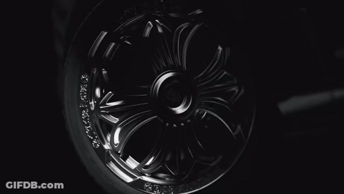 A Close Up Of A Chrome Wheel With The Letter H On The Center GIF