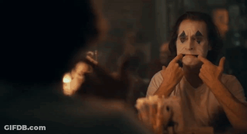 Close Up Clown Making Face With Fingers GIF