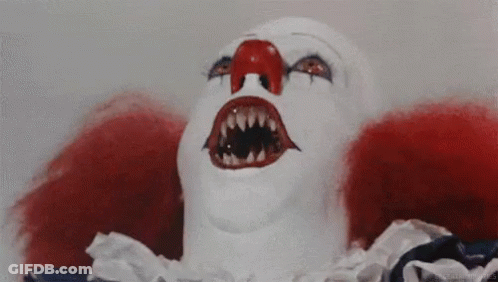 A Close Up Of A Clown 'S Face With A Red Nose And Teeth . GIF