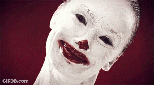 A Close Up Of A Clown 'S Face With Blood On It GIF