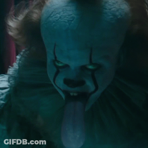 A Close Up Of A Clown 'S Face With His Tongue Sticking Out GIF