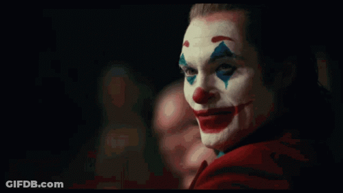 A Close Up Of A Clown With A Red Cape On GIF