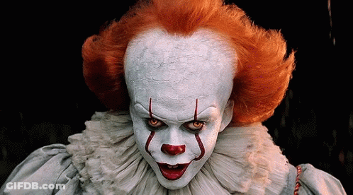 A Close Up Of A Clown With Red Hair GIF