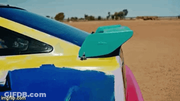 A Close Up Of A Colorful Car With A Spoiler On The Back Of It . GIF