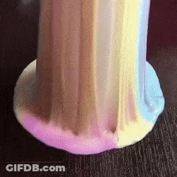 A Close Up Of A Colorful Slime On A Table . GIF
