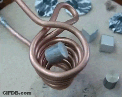 A Close Up Of A Copper Coil With A Piece Of Metal Inside GIF