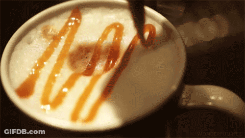 A Close Up Of A Cup Of Coffee With Caramel Sauce GIF
