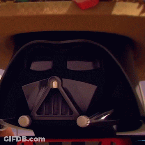 A Close Up Of A Darth Vader Helmet With A Red License Plate On It GIF