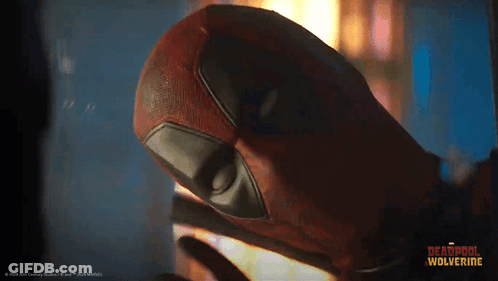 A Close Up Of A Deadpool Mask With The Words Deadpool Wolverine On The Bottom Right GIF