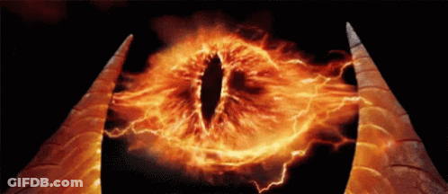 A Close Up Of A Demon 'S Eye With Fire Coming Out Of It GIF
