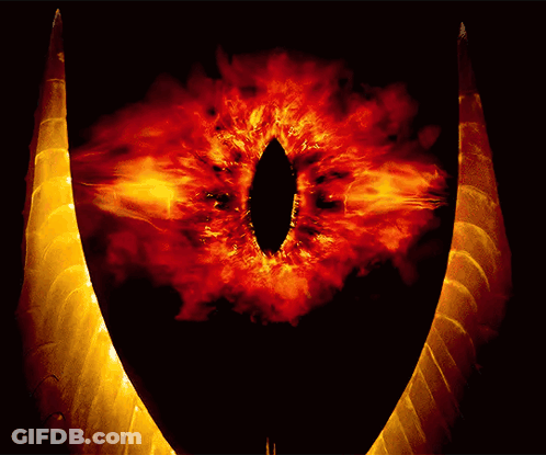 A Close Up Of A Demon 'S Eye With Flames Surrounding It GIF