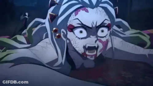 A Close Up Of A Demon Slayer Anime Character With A Bloody Face Laying On The Ground . GIF