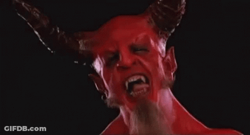 A Close Up Of A Devil With Horns And Fangs On A Black Background . GIF
