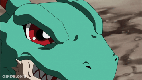 A Close Up Of A Dinosaur 'S Face With Red Eyes And Sharp Teeth GIF