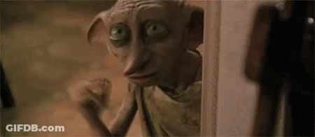 A Close Up Of A Dobby From Harry Potter Looking Out Of A Doorway . GIF
