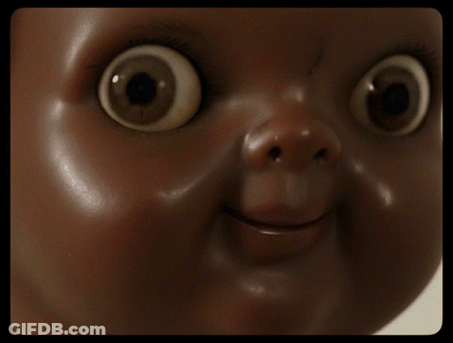 A Close Up Of A Doll Face With Big Eyes GIF