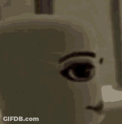 A Close Up Of A Doll 'S Face With A Smile . GIF