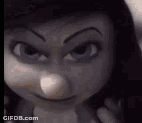 A Close Up Of A Doll 'S Face With An Angry Look On It . GIF