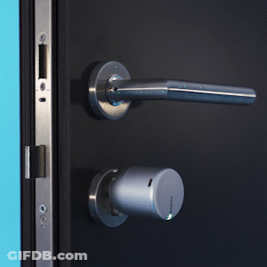 A Close Up Of A Door With A Handle And A Key GIF