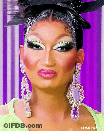 Drag Queen With Earrings And Feathered Hat GIF