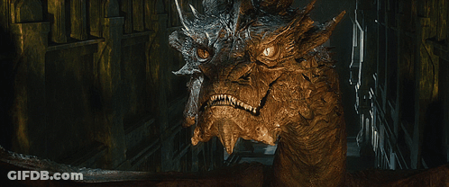 A Close Up Of A Dragon 'S Face Looking At The Camera GIF