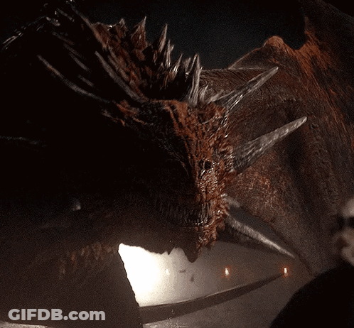 A Close Up Of A Dragon 'S Face With A Few Lights In The Background GIF