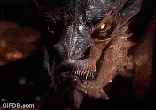 A Close Up Of A Dragon 'S Face With Its Eyes Glowing GIF