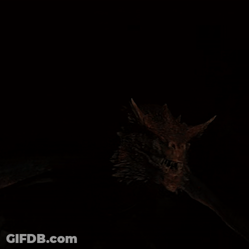 A Close Up Of A Dragon 'S Head Showing Its Teeth GIF