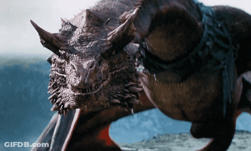 A Close Up Of A Dragon 'S Head With Horns And Wings GIF