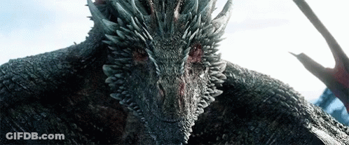 A Close Up Of A Dragon 'S Head With Sharp Teeth GIF