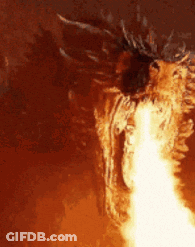 A Close Up Of A Dragon With Flames Coming Out Of Its Mouth GIF