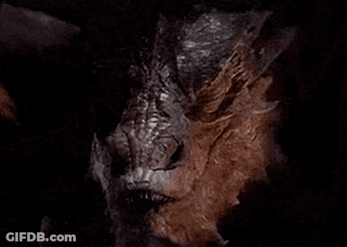 A Close Up Of A Dragon With Sharp Teeth GIF