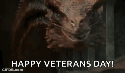A Close Up Of A Dragon With The Words `` Happy Veterans Day '' Written Below It . GIF