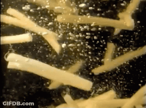 A Close Up Of A Few Pieces Of Cheese On A Black Surface GIF