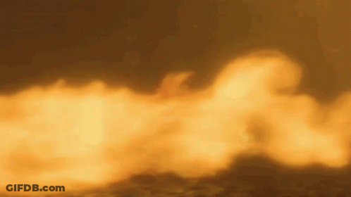 A Close Up Of A Fire With Smoke Coming Out Of It Against A Dark Background . GIF