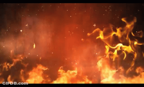 A Close Up Of A Fire With Sparks Flying In The Air On A Black Background . GIF