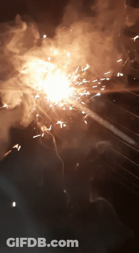 A Close Up Of A Fireworks Display With Sparks And Smoke Coming Out Of It GIF