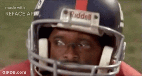 A Close Up Of A Football Player Wearing A Helmet And Looking At The Camera . GIF