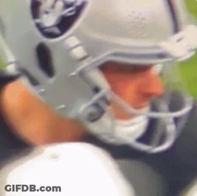 A Close Up Of A Football Player Wearing A Helmet That Says Raiders On It GIF