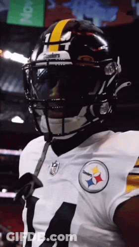 A Close Up Of A Football Player Wearing A Helmet That Says Steelers On It GIF