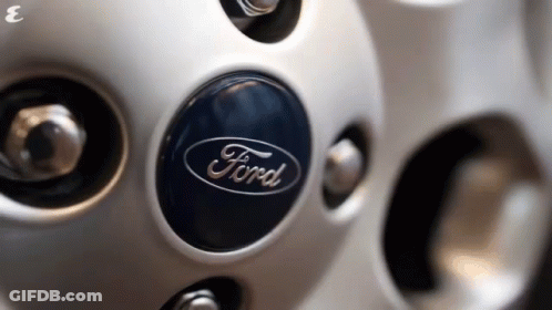 A Close Up Of A Ford Wheel Emblem GIF