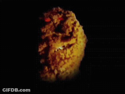A Close Up Of A Fried Chicken Nugget With Red Eyes GIF