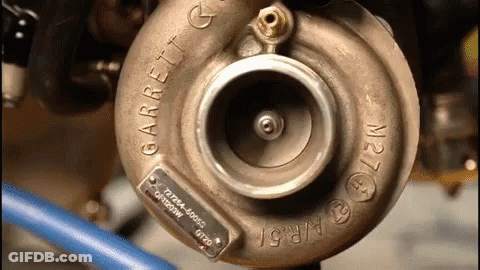 A Close Up Of A Garrett Turbocharger On A Vehicle GIF
