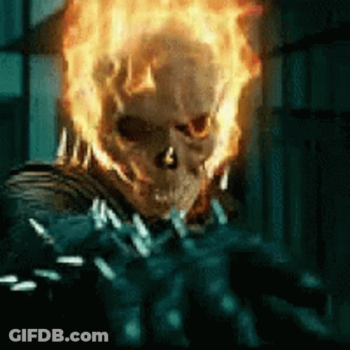 A Close Up Of A Ghost Rider With Flames Coming Out Of His Face GIF